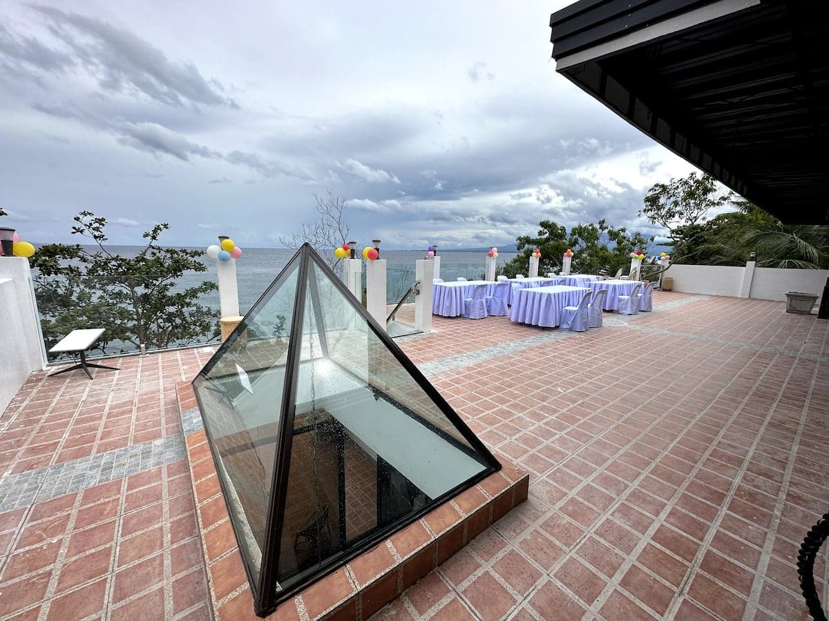 The villa rooftop terrace set for a gathering over the sea