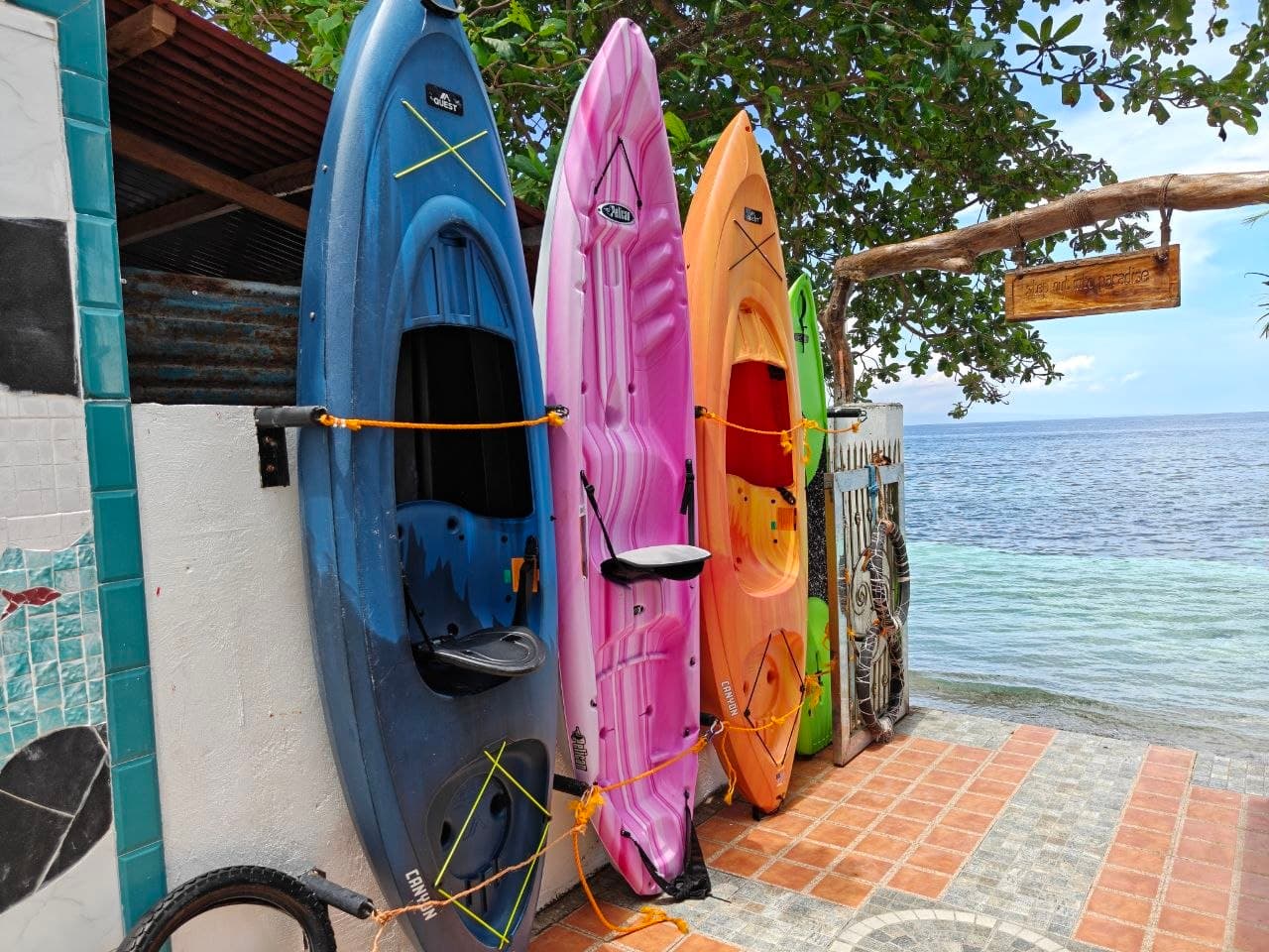 Colorful canoes and kayaks stored by the G Boutique sea gate
