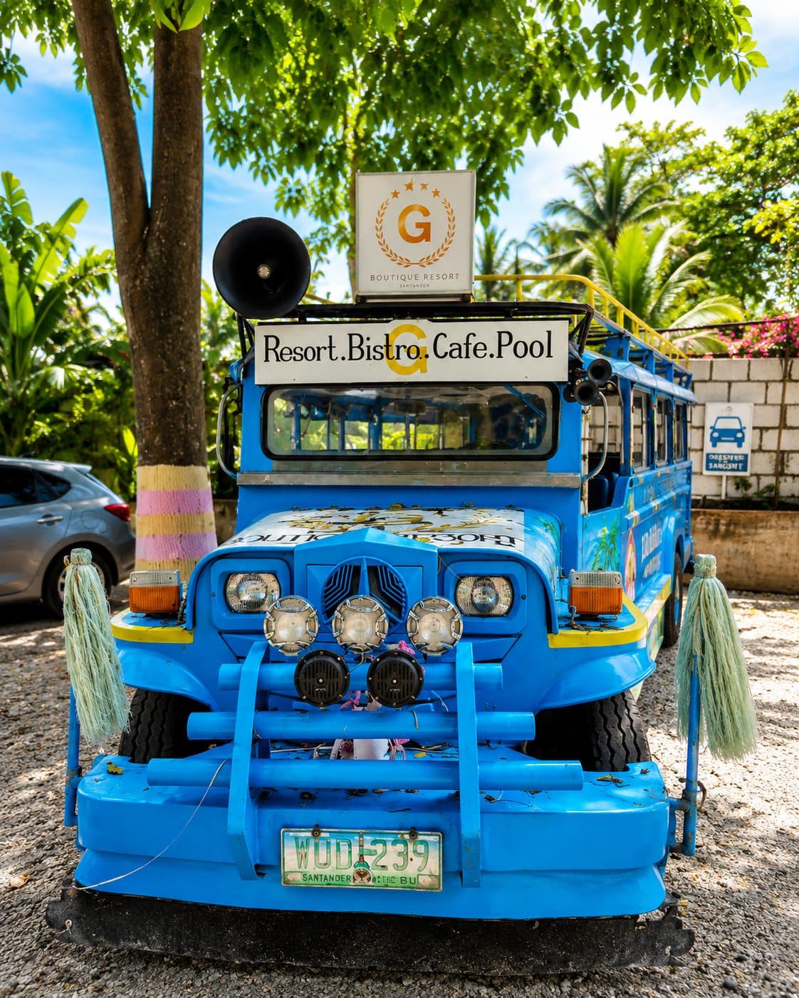 The blue G Boutique shuttle at the resort gate